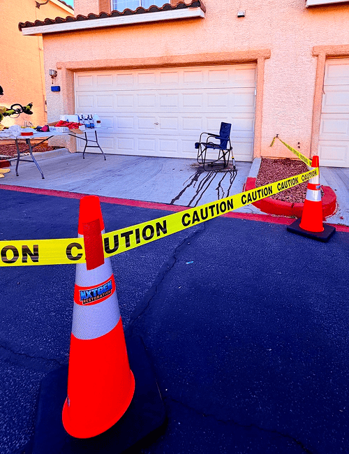 Driveway with caution tape and traffic cones