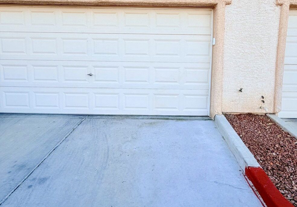 White residential garage door and concrete driveway